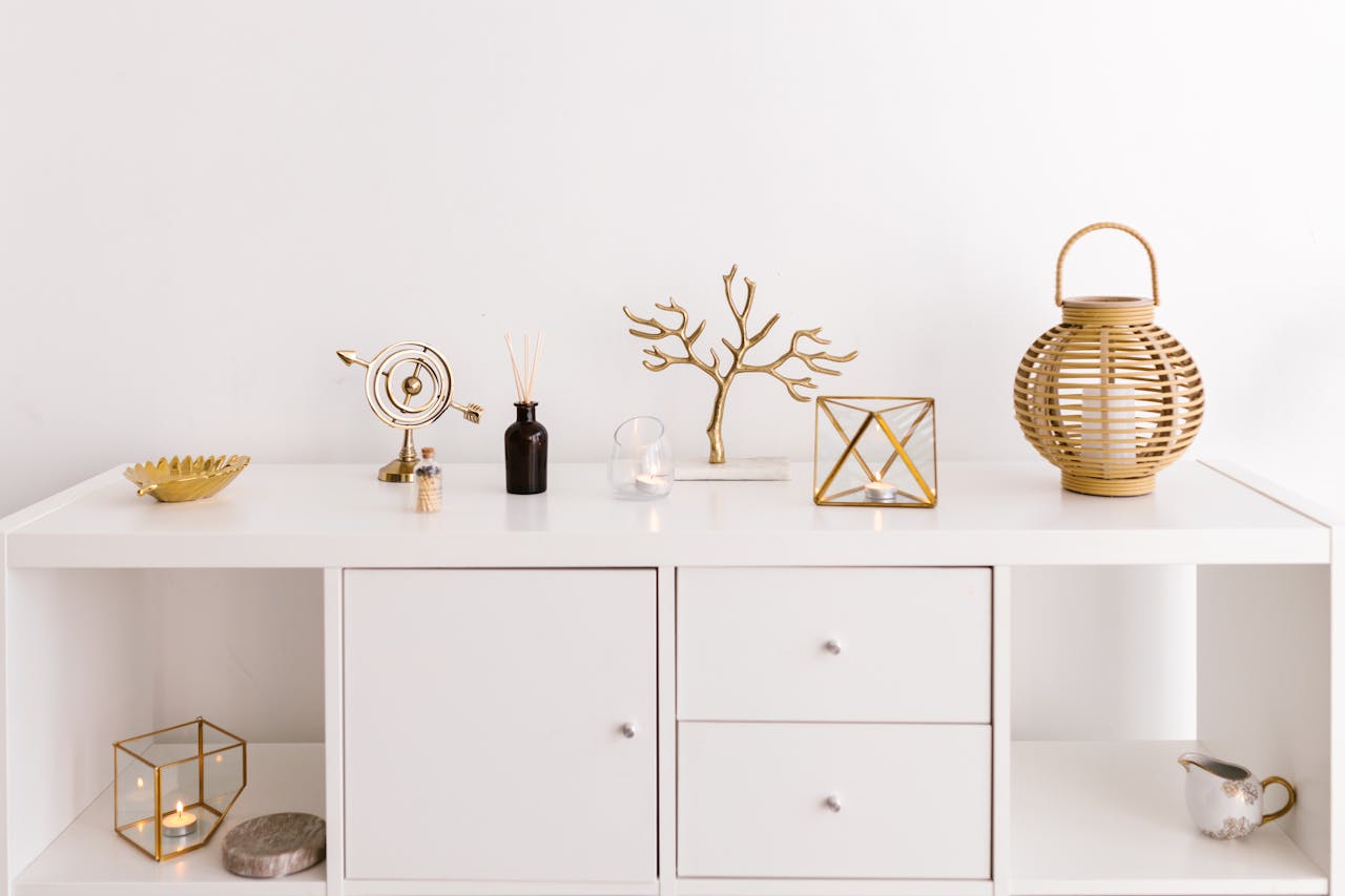 Sleek white cabinet with elegant gold decorations on a modern white background